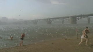 Dramatic storm Freak Russian hailstorm sends beachgoers screaming on hot summer day [upl. by Airdnaz]