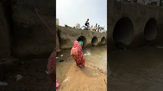 A woman catches fish from a large dam with a hook  amazing fishing in the canal  fishing shorts [upl. by Glynias]