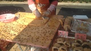 Bees swarm calm street vendor in China [upl. by Tiff530]