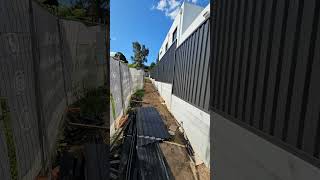 Colourbound fence on top of the concrete sleeper retaining wall fencebuilding fence fenceline [upl. by Ahsenod210]