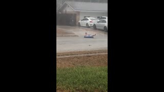 Child tubes down flooded street on her birthday [upl. by Tterb]