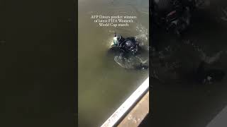 AFP Divers tossed a coin into the water to predict who will win tonights FIFAWWC match [upl. by Aliet]