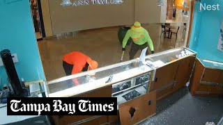 Watch Robbers use sledgehammer to break open jewelry cases at WestShore Plaza mall [upl. by Merrie]