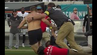 Fan causes a spill running onto field at Jaguars game [upl. by Enneicul]