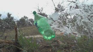 17 HMR Slow Motion Bottle Shot  20gr Hornady XTP rounds at 100yds [upl. by Claudy]