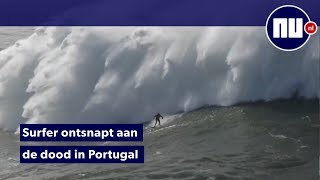 Surfer overspoeld door vijf gigantische golven in Portugal [upl. by Stronski]