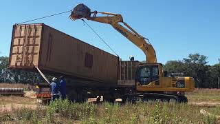 Off loading a 40ft container Komatsu Pc220 [upl. by Esiole351]