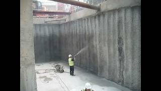 Spray application of Vandex Unimortar 1 tanking slurry to piled basement retaining wall [upl. by Leirua]