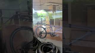 Tiny Wheels shopping window with one last Moulton bike and nearby pond 72024 [upl. by Nehgam]