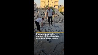 Palestinians write names of the dead on rubble of their home  AJ shorts [upl. by Brubaker577]