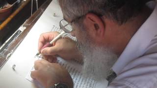 A scribe begins to write a new Torah scroll Genesis The ancient synagogue at Masada Israel [upl. by Teemus]