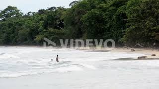 Young girl running into the water of the Caribbean sea at Cahuita National Park [upl. by Nola]