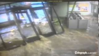 Dramatic footage Flash flood rips off doors engulfing school lobby in Illinois [upl. by Swee769]