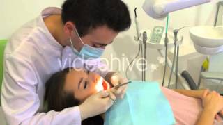 Dentist Examining Treating a Girls Teeth Mouth Mirror Dental Hook Dental Lamp Male Stomatologist [upl. by Notsniw765]