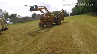 Ford 4400 tractor loading round bales of hay [upl. by Nellad]