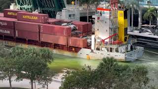 Tugboats pulling freighter backwards through Miami river [upl. by Eahs]